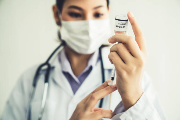 istock Skillful doctor prepare vaccine proficiently before injection . Covid 19 and coronavirus vaccination center service concept . 1463851793