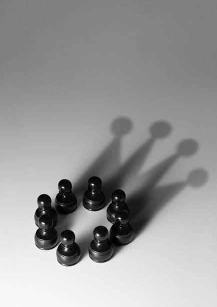 Black pawn standing and white pawns lying down.