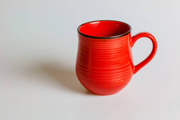 istock Blank red mug isolated on white background,mat tea or coffee cup,mock up with ceramic mug for hot drinks,empty gift print branding template,tankard for design,placement for logo. 1463854677