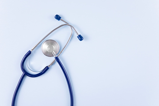 Stethoscope on blue background with copy space