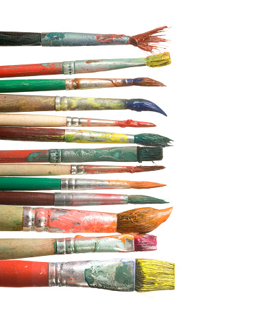 Set of paintbrushes with multi colored strokes on white paper sheets.