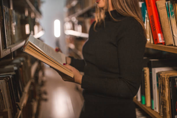 istock An unrecognizable female librarian is reading a book in the library 1463858130