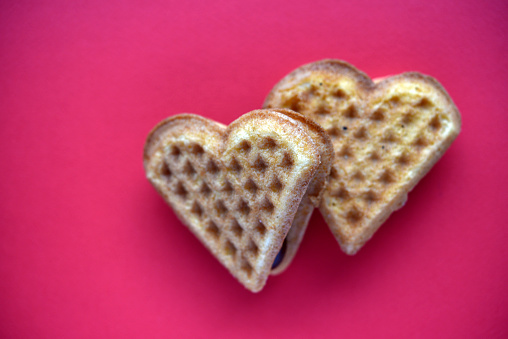 Waffle hearts on a red background. Valentine's day. Confectionery products in the form of a heart.