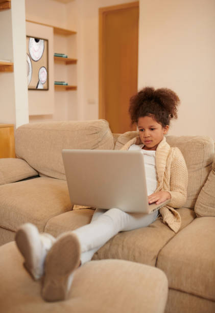 istock A curly-haired girl spending time on internet and looking involved 1463863077