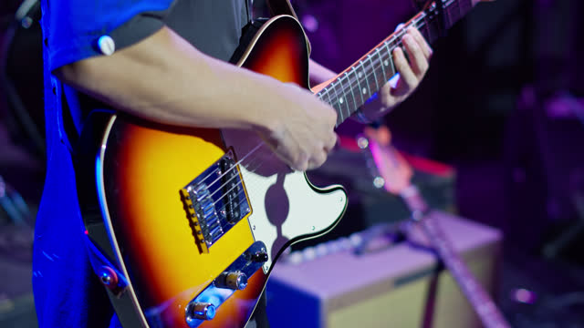 Close Up of Man Playing Guitar During Sound Check in Slow Motion