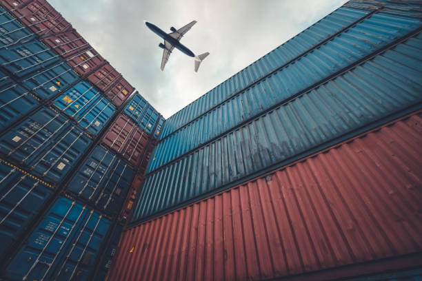 istock Freight airplane flying above overseas shipping container . Logistics supply chain management and international goods export concept . 1463864379