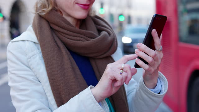 Woman using phone at Regent Street, London