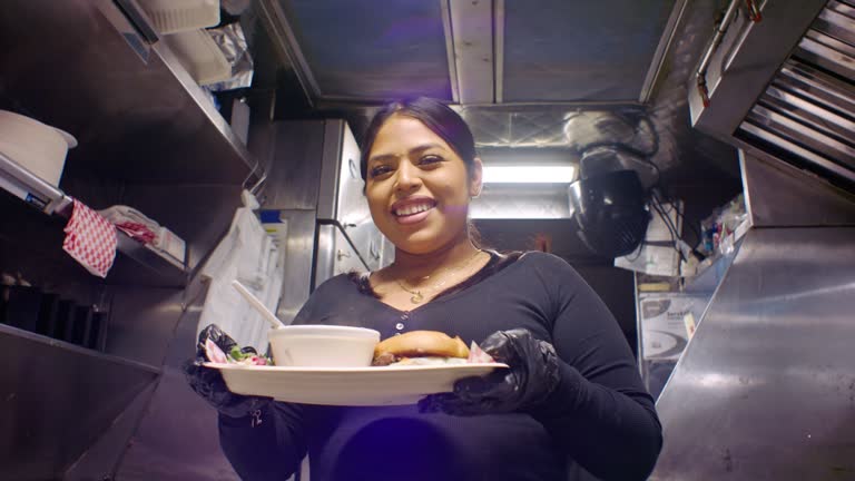 Handheld Shot of Latina Food Worker Presenting Order For Camera