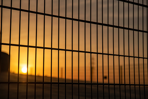 Beautiful sunset seen through the iron fence