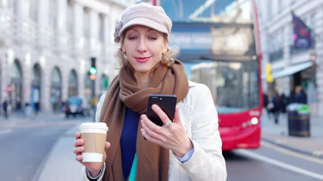 Woman using phone at Regent Street, London