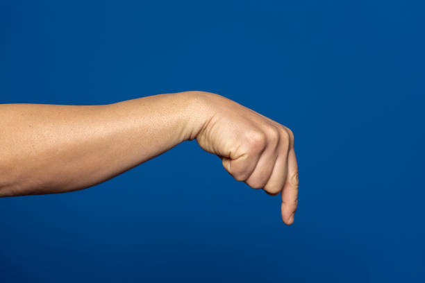 istock Strong hand of man pointing index finger down isolated on blue background. 1463867847