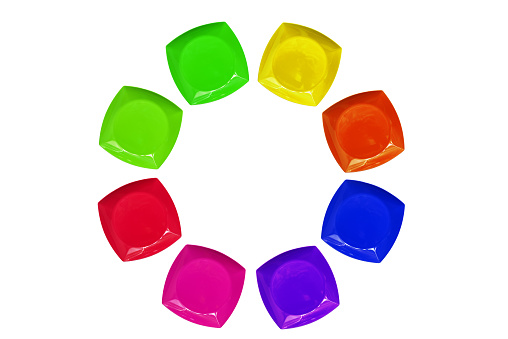 Group of multi colored plastic plates in a circle arranged