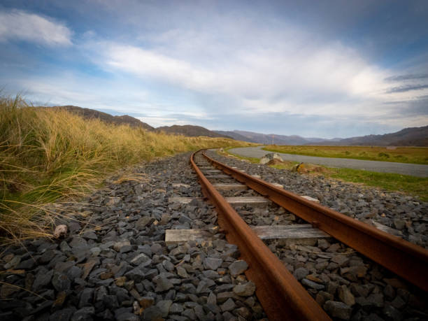 istock Narrow gauge railway track at sunset on the beach 1463869719