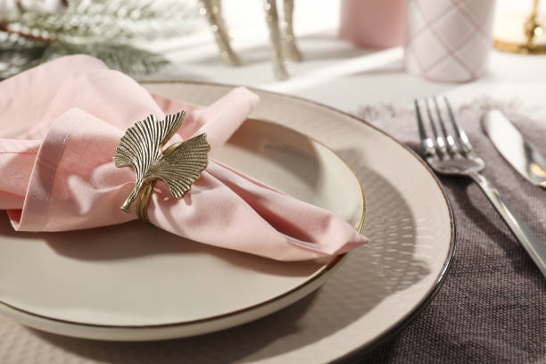 istock Stylish table setting with pink fabric napkin, beautiful decorative ring and festive decor on white background, closeup 1463869880