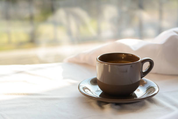 istock Aromatic morning coffee on bed indoors, space for text 1463870923