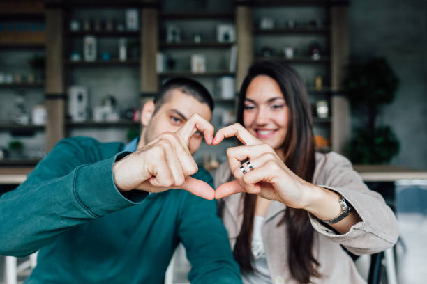 istock Woman and man making heart shape with hands 1463871431