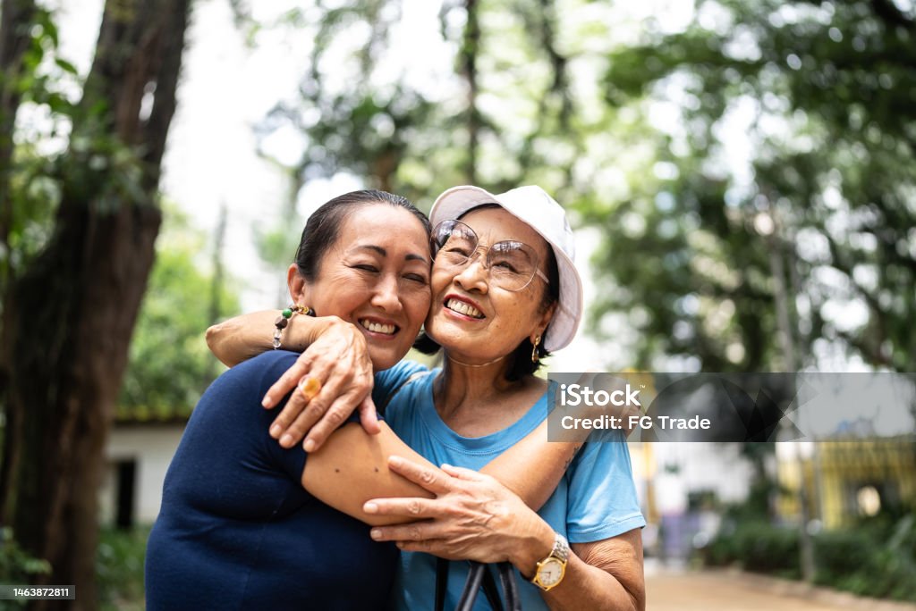 Mother and daughter embracing on the public park Senior Adult Stock Photo