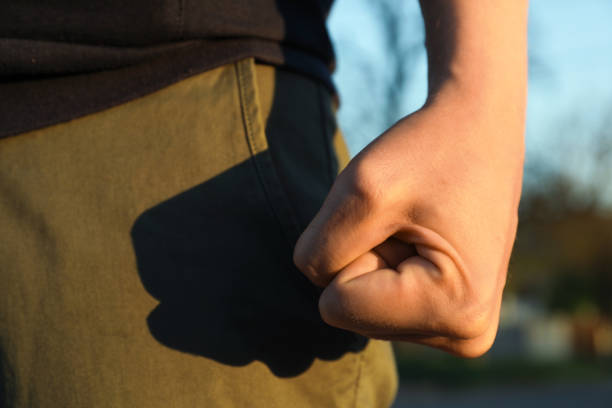 istock Angry man with clenched fist outdoors, closeup 1463873345