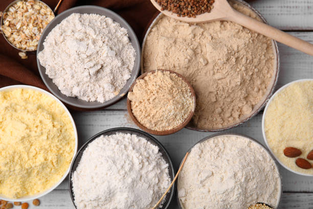 istock Bowls with different types of flour on white wooden table, flat lay 1463873708
