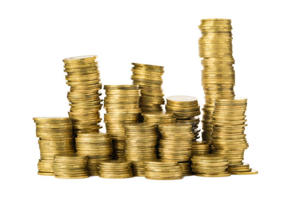 istock Many golden coins stacked on white background 1463873732