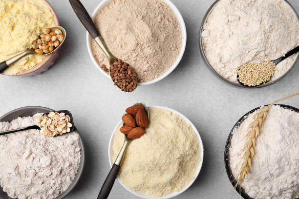 istock Bowls with different types of flour and ingredients on light grey table, flat lay 1463873750