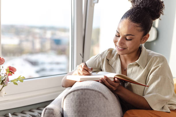 istock Young African American woman writing notes 1463874498