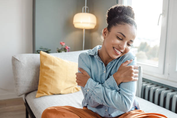 istock Smiling beautiful woman hugging self 1463875206