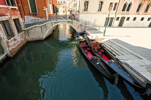 Canal with two gondolas in Venice, Italy.