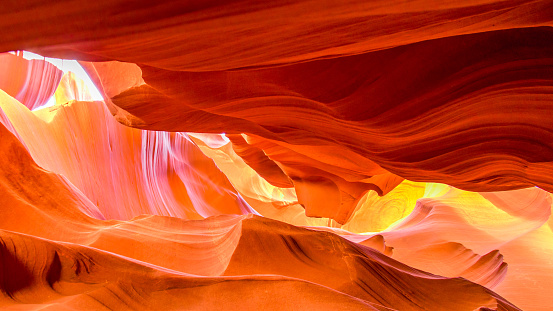 Colorful Light in Upper Antelope Canyon. Light showing off the detail of the rock arches. Light and colors in Upper Antelope Canyon. Rock texture with red, magenta and orange colors. Rock formation, game of lights.