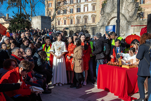 Rome, Italy - February 5, 2023: Citizens of the Chinese community celebrate their New Year party in the Italian capital. The event is open to the public with performances of dance, martial arts and traditional Chinese music. In the photo, the girls offer tea to the personalities present.