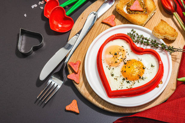 istock Heart-shaped fried egg served with toasted bread. Romantic art food idea for Valentine's breakfast 1463879945