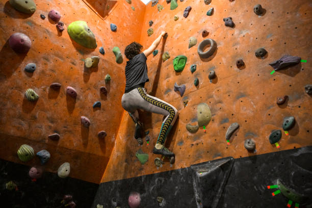 istock Woman practicing rock climbing at an indoor climbing gym 1463881662