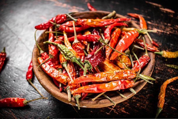 istock Wooden plate with dried chili peppers. 1463883288