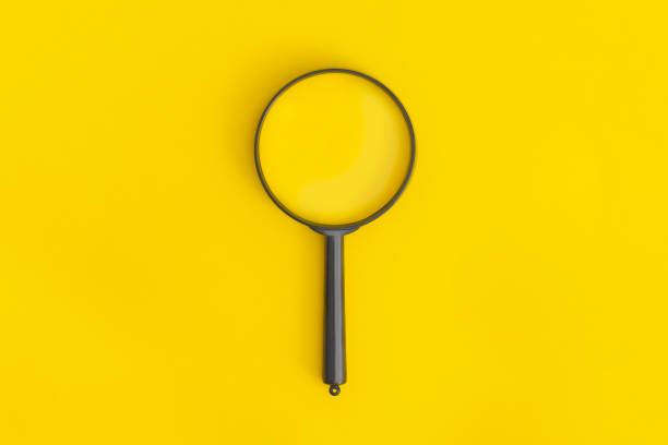 istock Magnifier on yellow backgroundMagnifier on yellow background 1463885299