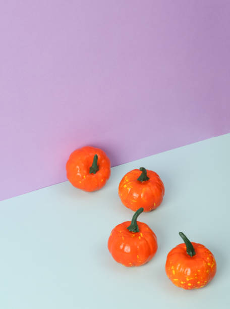Plastic decorative Halloween pumpkins on a pastel background. Minimal halloween still life. Creative layout. Trick or Treat