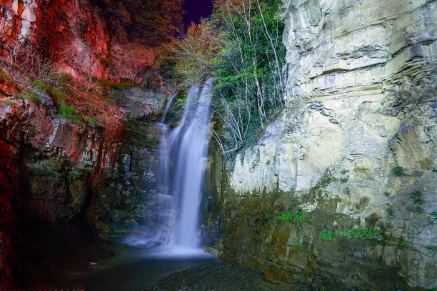 The amazing Legvtakhevi waterfall in Tbilisi at night in the city center next to the sulfur baths. On the right is a red light.