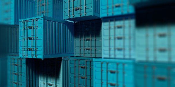 3D rendered blue color containers with import, export, trade concept. Stacked containers in shallow depth of field as a background.