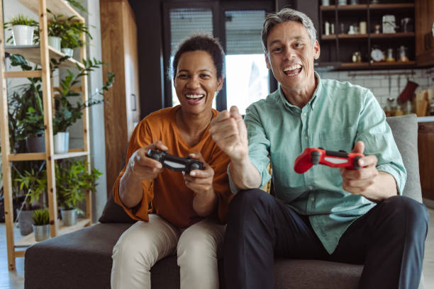 istock Excited mature couple playing video games on a console 1463887357