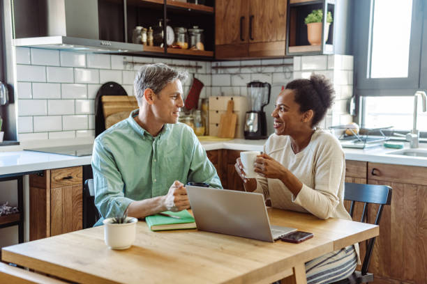 istock Cheerful mature couple discussing home finances at home 1463887721