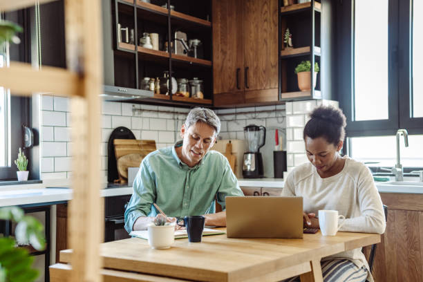 istock Mature couple using laptop at home 1463887722