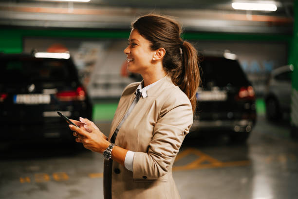 istock Businesswoman in suit unlocking car on parking 1463888558