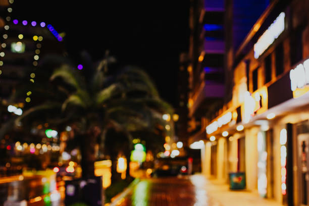 Evening blurred view of a street with traffic lights and illuminated buildings in Budva, Montenegro.