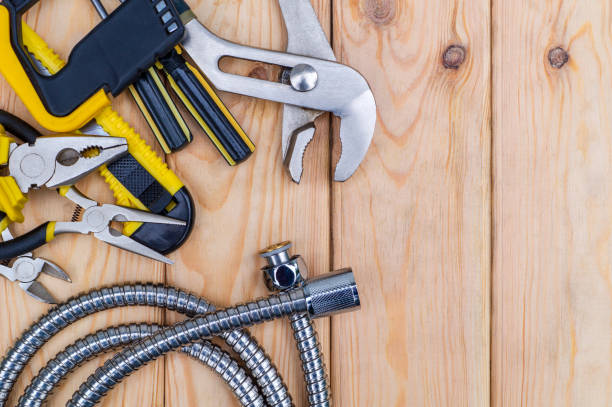 istock Necessary set of tools for plumbers on wooden background 1463892719
