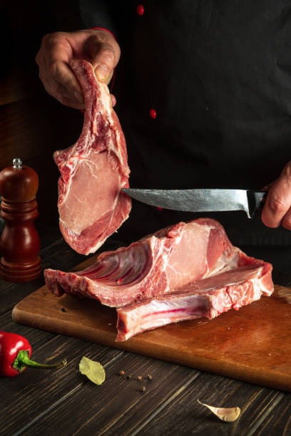 istock A professional chef cuts raw ribs on a cutting board before baking. Asian cuisine. Cooking delicious food in the kitchen 1463893926
