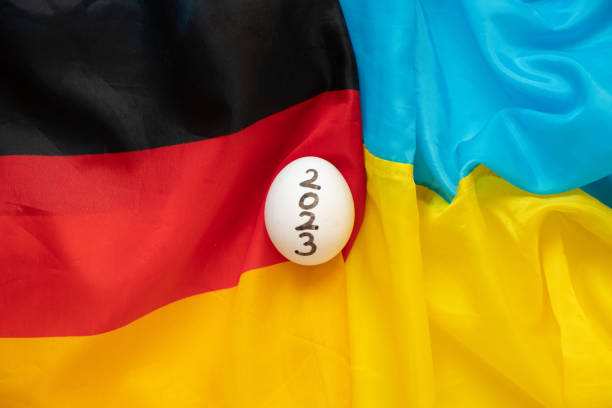 istock Flags of Ukraine and Germany and between them a chicken egg with the text 2023 1463893950
