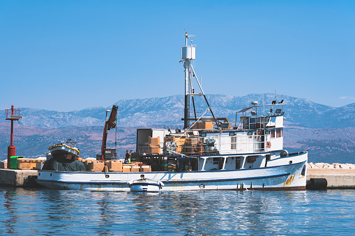 A fishing boat in the port from which fishermen unload their cargo.