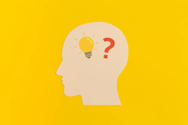 istock Human head with a question mark and lightbulb on yellow backgroundkground 1463894595
