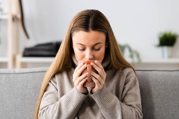istock Young woman smelling cup of coffee 1463895800