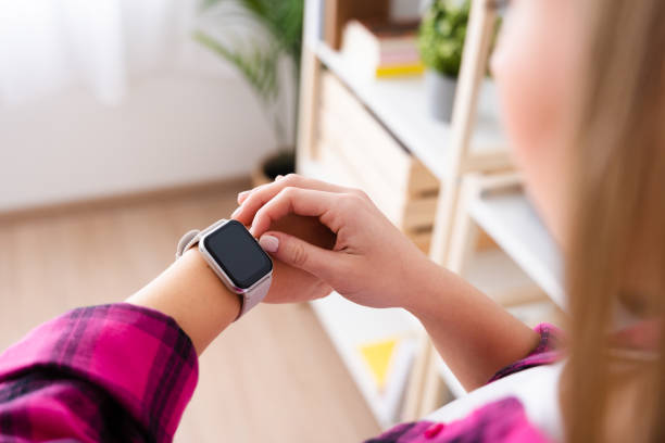 istock Unrecognizable woman checking smartwatch indoors 1463896374