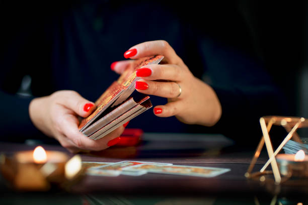 Blurred Witch woman using tarot cards for love spelling, witchcraft, divination and fortune telling. Magic illustration and alchemy